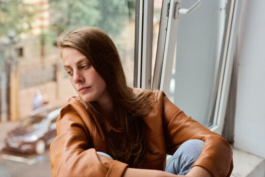 Woman sitting by the window