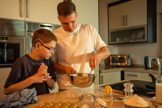 Brothers Prepare a Meal Together in the Kitchen at Night