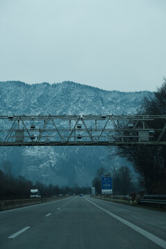 Empty autobahn with few cars, road cameras and snowy mountains 