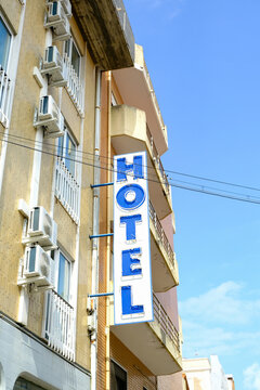 Vertical Hotel Sign on Urban Building