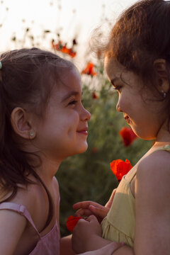 The sisters are standing in a field