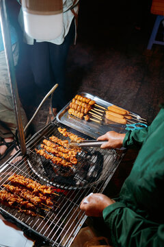 Grilling delicious skewers at a night market in Vietnam 