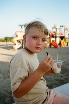 Boy with Slushie at Beach Playground