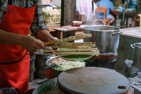Woman cooking a Thai traditional dish Mee Phan