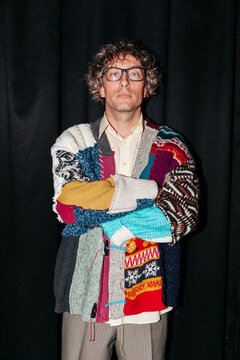 Fashion event features a person wearing a colorful knitted sweater