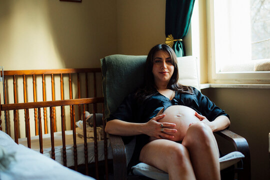 Pregnant Woman Sitting by Window Light