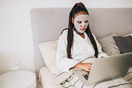 Portrait of african american woman with face mask working from home