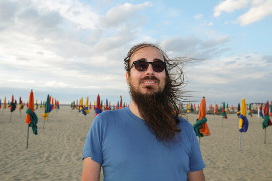 Man with Sunglasses and Long Hair on Beach