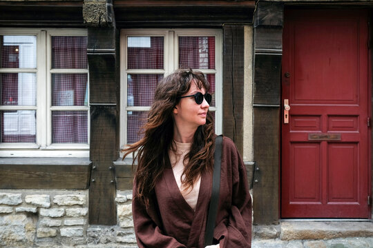 Woman in front of red door