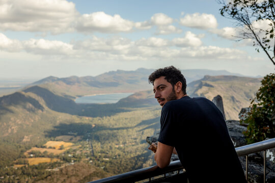 Man overlooking mountains and lake