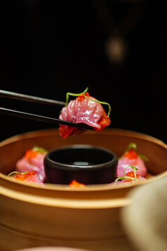 Close-Up of Pink Dumpling with Chopsticks