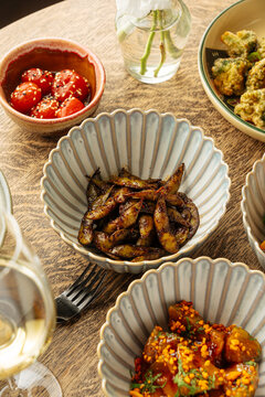 Assorted Asian Dishes on Wooden Table