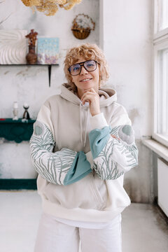 woman in a hoodie standing in a bright room