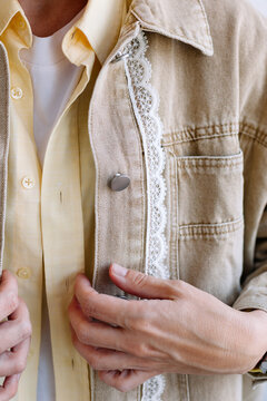 Close look at hands adjusting clothing