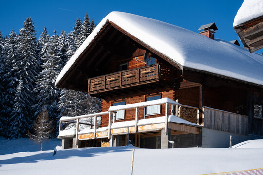 Wooden chalet with snow covered roof