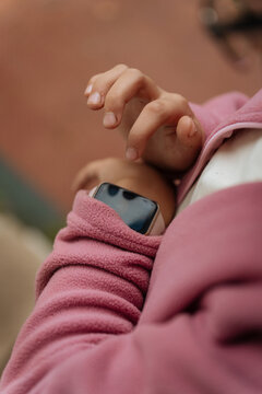 Hand interacting with smartwatch