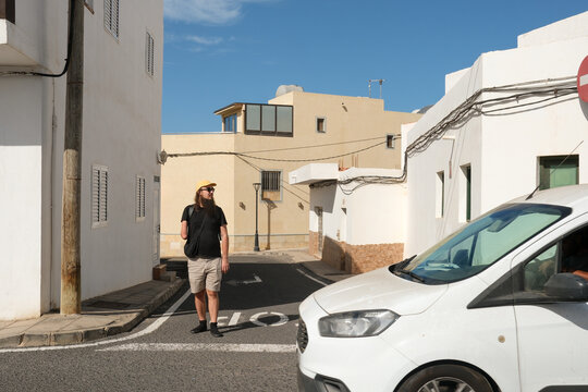 Person Walking Through Village Street
