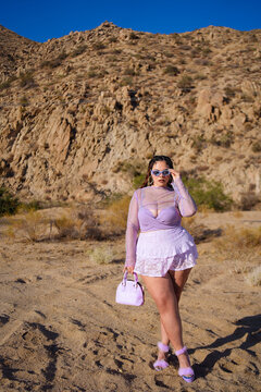 Stylish woman Posing Confidently in the Desert  in Bold Lavender 