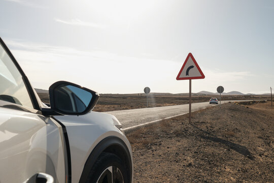 Car Parked Beside Desert Road Sign