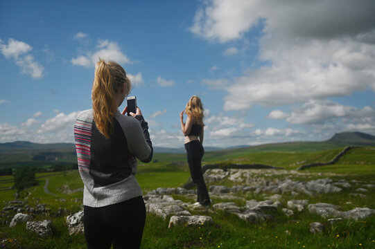 2 sisters taking photos in the English Countryside