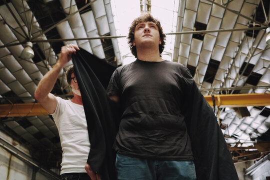 Man Getting Dressed in a Workshop With Industrial Features