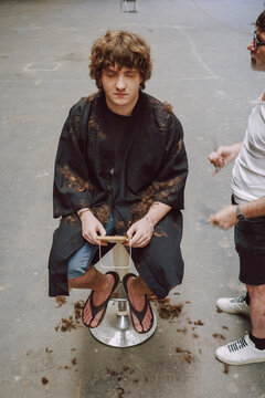 Getting a Haircut in a Studio With Scattered Hair