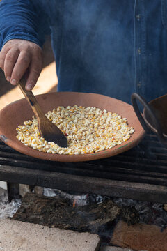 Stirring Corn on a Clay Dish Over Open Fire