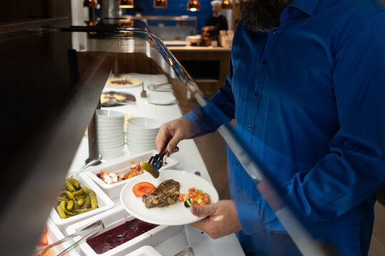 Catering Service Employee Serving Food at Buffet