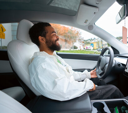 Man drives electric car in city
