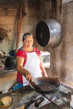 Woman Cooking with Traditional Pan