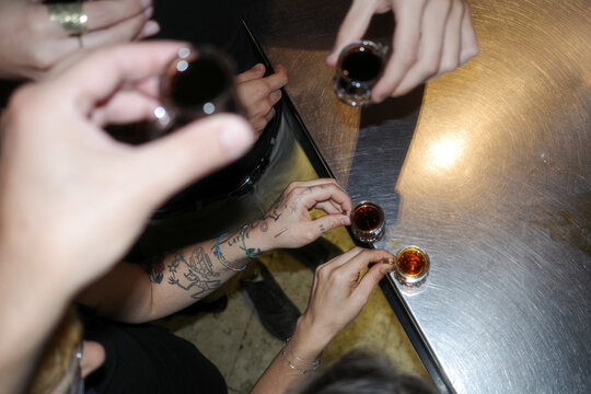 Anonymous people making a toast with shots