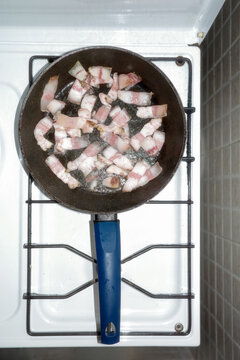 Bacon in a Frying Pan on a Kitchen Stove 