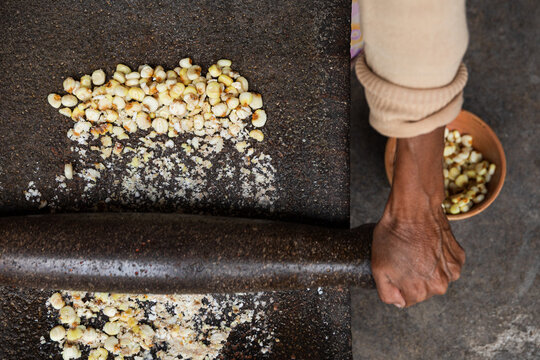 Crushed Corn Spreading Out on Stone Surface