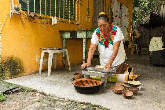 Woman preparing food in a rustic outdoor kitchen in Veracruz Mexico
