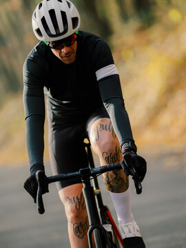 Tattooed Cyclist sprinting on his bicycle