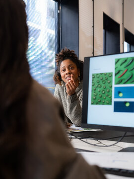 Women talking at office while working 