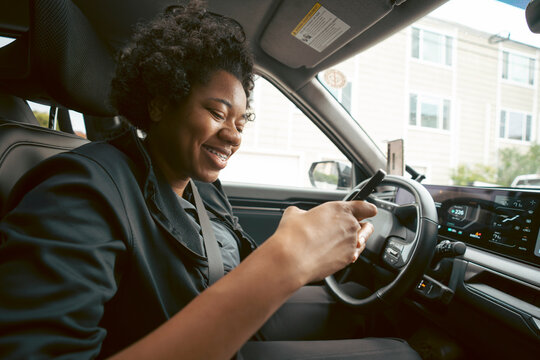 Woman using phone in car

