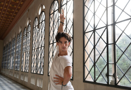 Male dancer with raised arm in ballroom
