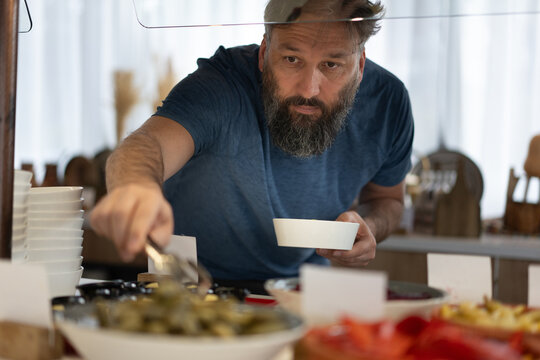 Man Serving Food at Buffet