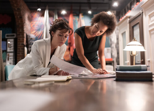 Multiethnic  female designers discussing project in workplace