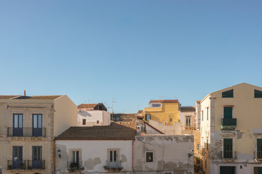 Old Town Rooftops Under Clear Blue Sky
