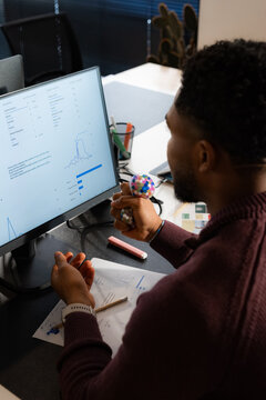 Person Working at Desk on Data Analysis Project in Office Setting
