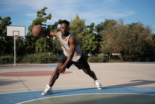 Black basketball player doing freestyle dribbling