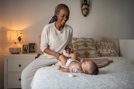 Mother is doing exercises with newborn baby 