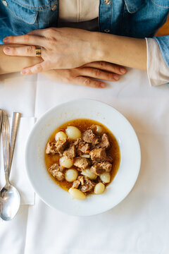  Stewed meat with pearl onions on white plate