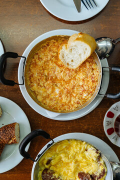 Turkish menemen and scrambled eggs with sausage