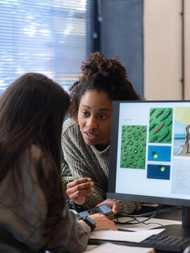Two Women Discuss Design Ideas in an Office
