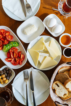 Traditional breakfast spread with cheese, eggs, and vegetables