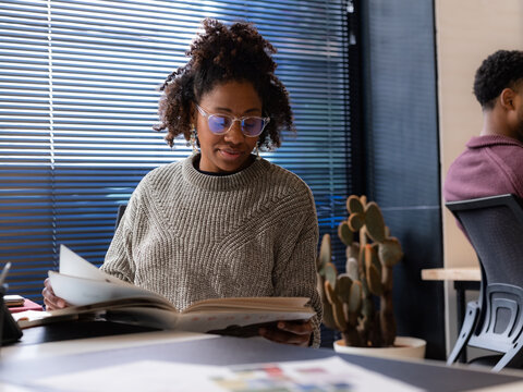 Woman reading magazine at work 