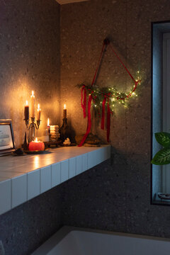 Warm Holiday Still Life with Candles and Evergreen Garland